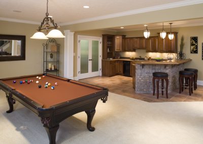 Lower level game room and bar in residential home.